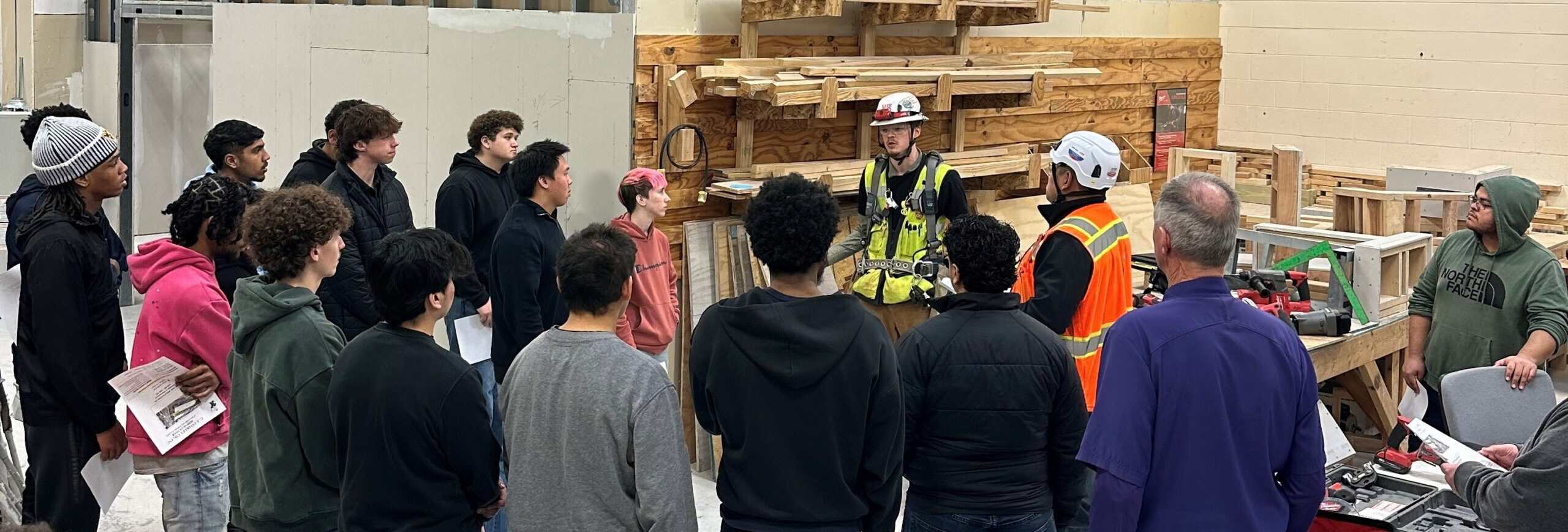 Group of students learning construction safety from professionals at NV3C.